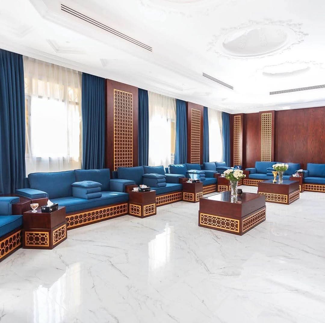Grand majlis with marble flooring and gold lattice wood panels