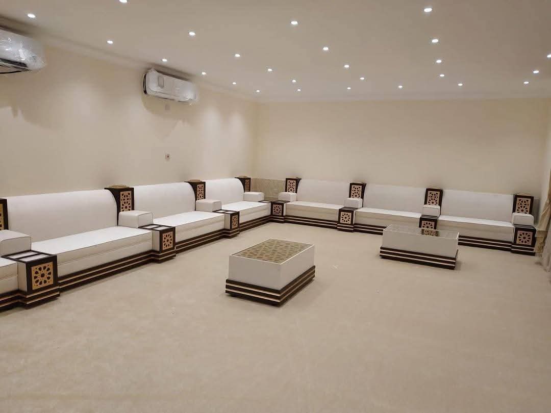 Majlis seating with inlaid wood trim and recessed ceiling lights